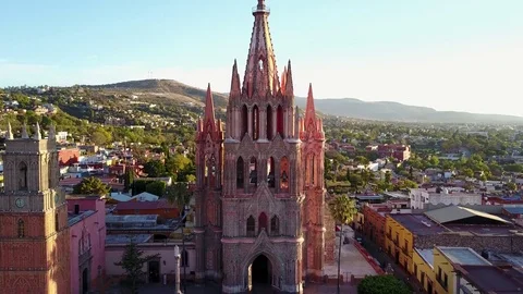 Aerial downward pan of beautiful and unique church and surrounding hillside Stock Footage