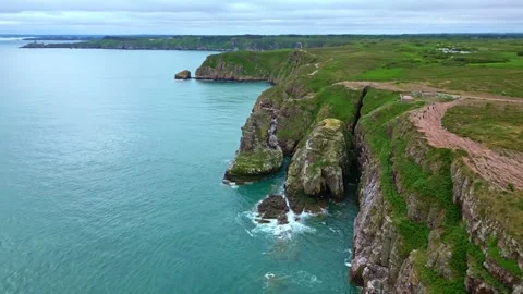 Aerial of dramatic cliffs and lighthouse at Cap Fréhel, France Stock Footage 312029244