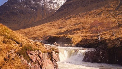 Aerial: Dramatic shot tracking up a waterfall in Glen Etive, Scotland. 4K Stock Footage 103170318