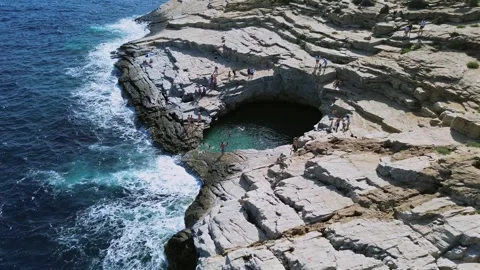 Aerial Dramatic View of Rugged Sea Cliffs and Natural Ocean Basin Stock Footage 331360796