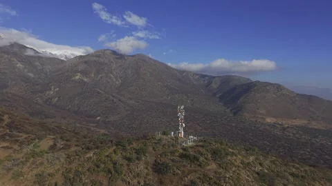 Aerial Drift Past Communications Tower in San Carlos de Apoquindo Stock Footage 338009260