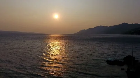 Aerial driving off from small hidden beach on sunset  Croatian Makarska coast. Stock Footage 80022740