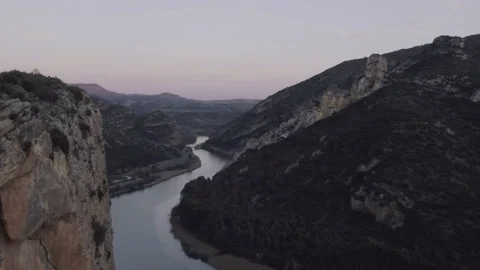 AERIAL DRON MOUNTAIN RANGE CLIFF AND RIVER REVEAL IN STUNNING CAYON Stock Footage 130434317