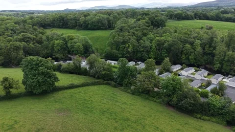 Aerial drone 4K view of caravan site in natural valley greenery Wales Видео 337296252