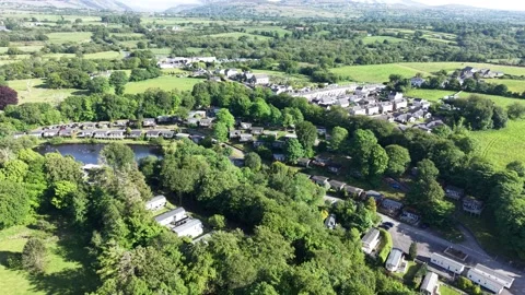 Aerial drone 4K view of caravan site near countryside meadow Wales Видео 337296597