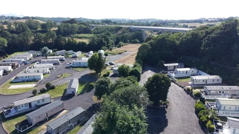 Aerial drone 4K view of caravan retreat across open countryside Wales Video stock 339806408