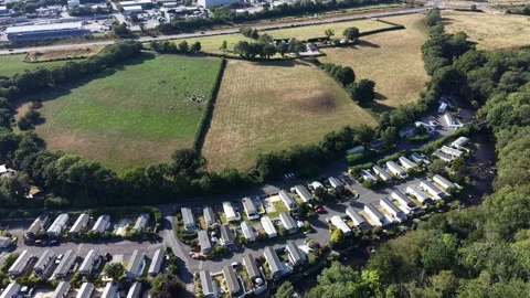 Aerial drone 4K view of caravan park across open farmland greenery Wales Video stock 339806932