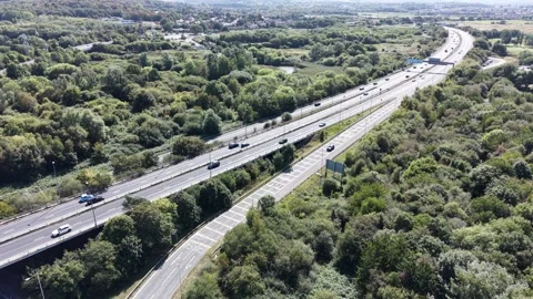 Aerial drone 4K view of M53 Wallasey motorway junction glowing in warm daylight Video stock 343158232