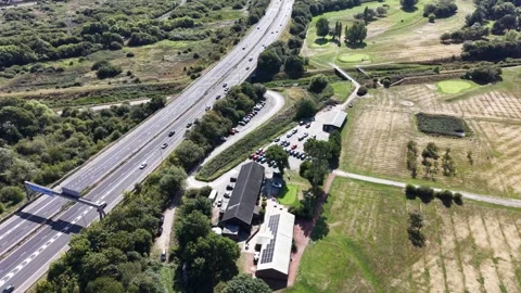 Aerial drone 4K view of M53 Wallasey motorway glowing across warm daylight Stock Footage 343160802