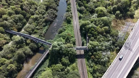 Aerial drone 4K view of Merseyside railway bridge glowing in warm sunlight Stock Footage 343158943