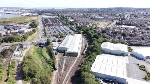Aerial drone 4K view of Merseyside train passing through warm sunlit countryside Stock Footage 343159239