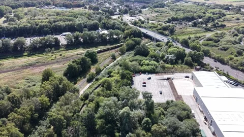 Aerial drone 4K view of Merseyside train glowing in warm sky daylight Merseyside Stock Footage 343159503