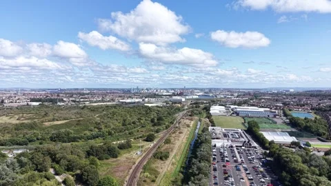 Aerial drone 4K view of Merseyside train travelling through warm daylight sky Stock Footage 343160696