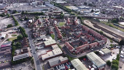 Aerial drone 4K view of town outskirts with surrounding green countryside Burton Видео 337301223