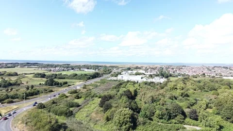 Aerial drone 4K view of Wallasey housing estate glowing in warm sky daylight Stock Footage 343157196
