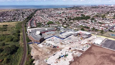 Aerial drone 4K view of Wallasey neighbourhood rooftops glowing in warm Stock Footage 343160170