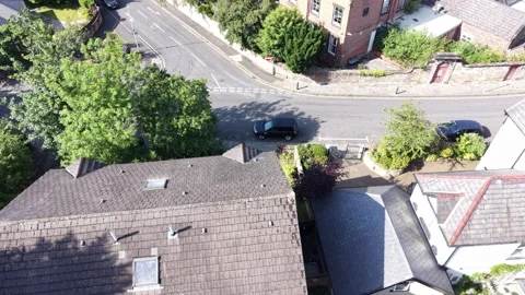 Aerial drone 4K view of Wirral rooftops in high sunlight Wirral Stock Footage 337833115