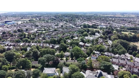 Aerial drone 4K view of Wirral residential streets glowing in warm daylight Video stock 342283443