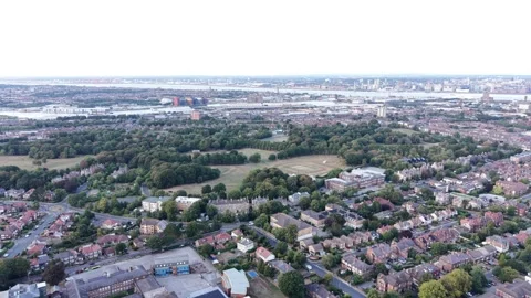 Aerial drone 4K view of Wirral residential rooftops glowing in warm afternoon Video stock 342285448