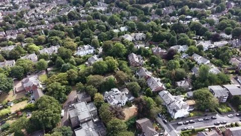 Aerial drone 4K view of Wirral housing blocks glowing in warm daylight sky Video stock 342285593