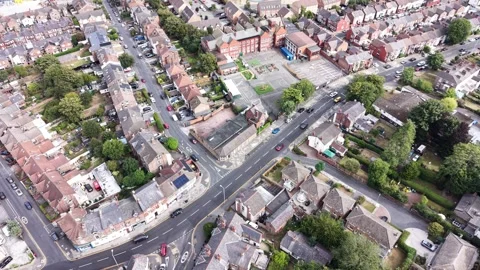 Aerial drone 4K view of Wirral rooftops glowing in warm afternoon daylight Stock Footage 342287461