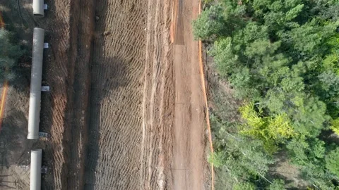 Aerial drone above construction site outside at nature with green trees around Stock Footage 131012995