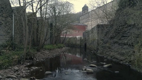 Aerial drone along river through village of Hebden Bridge Yorkshire Stock Footage 110824085