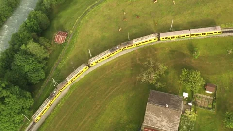 Aerial Drone of Alpine Train Moving Through Mountain Landscape At Grindelwald Stock Footage 314662923