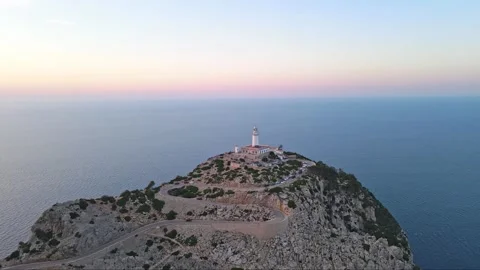 Aerial, drone and a lighthouse in the ocean during the sunset or sunrise Stock Footage 270212805