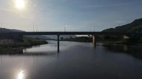 Aerial Drone Approach Along River Toward Highway Bridge in Central Vietnam Stock Footage 337807901