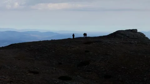 Aerial drone approaching hikers exploring the natural beauty of Serra da Estrela Stock Footage 296009597