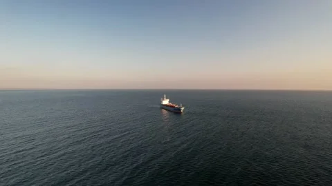 Aerial drone approaching a large marine vessel used for logistics import export Stock Footage 247445571