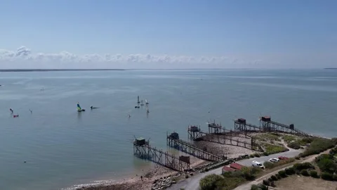 Aerial Drone backward tracking shot of traditional fishing huts on stilts Video stock 316063764