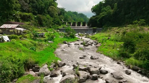 Aerial drone beautiful river flow dam aqueduct forrest hill village Видео 265378878