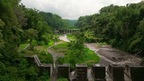 Aerial drone beautiful river flow dam aqueduct forrest hill village Видео 265398564