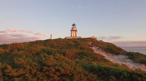 Aerial Drone Bonifacio headlight sunset and moon Stock Footage 61709588