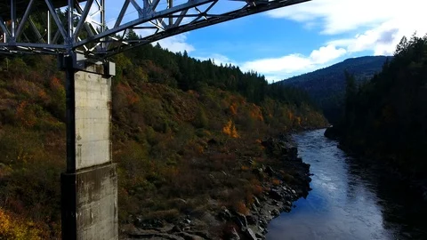 Aerial drone up a bridge truss with fall colors 스톡 동영상 113847669