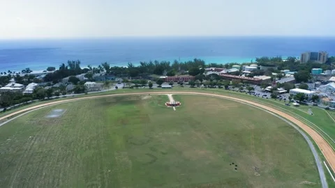 Aerial drone camera approaching the gate of .Garrison Savannah racecourse Video stock 136389554