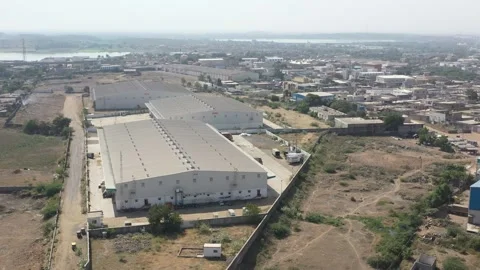 The aerial drone camera is moving over the road where many vehicles are moving 動画素材 259557684