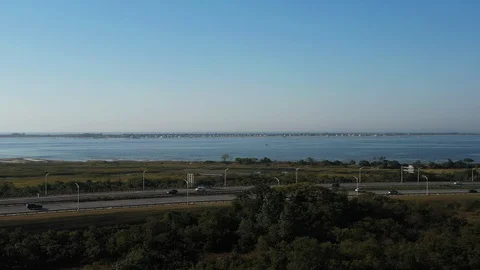 Aerial drone camera pull away &amp; pan right over Shell Bank Creek in Video stock 117677859