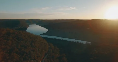 Aerial Drone camera tracking back sunset view forrest valley river 4K UHD Stock Footage 73590656