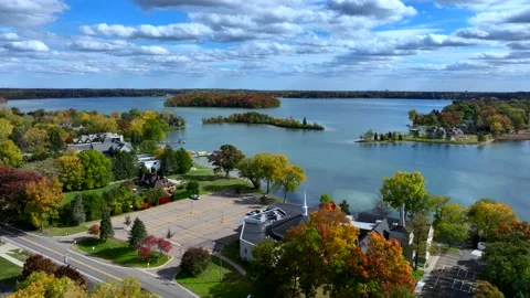 Aerial drone captures stunning fall colors at Orchard and Cass Lakes in Michigan Stock Footage 220035235