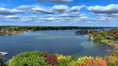 Aerial drone captures stunning fall colors at Orchard and Cass Lakes in Michigan Stock Footage 220035238