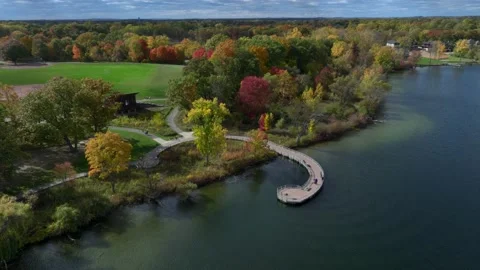 Aerial drone captures stunning fall colors at Orchard and Cass Lakes in Michigan Stock Footage 220035239