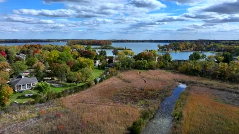 Aerial drone captures stunning fall colors at Orchard and Cass Lakes in Michigan Stock Footage 220035240