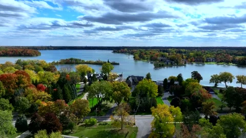 Aerial drone captures stunning fall colors at Orchard and Cass Lakes in Michigan Video stock 220035246