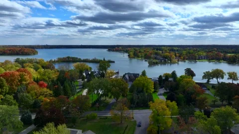 Aerial drone captures stunning fall colors at Orchard and Cass Lakes in Michigan Stock Footage 220035247