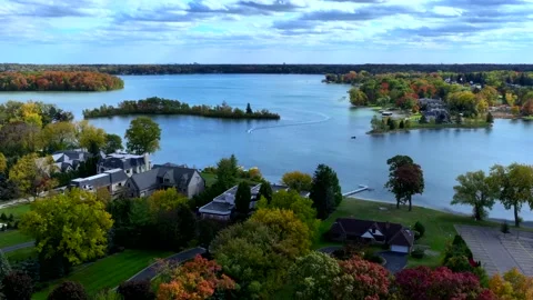 Aerial drone captures stunning fall colors at Orchard and Cass Lakes in Michigan Stock Footage 220035255