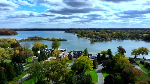 Aerial drone captures stunning fall colors at Orchard and Cass Lakes in Michigan Video stock 220035261