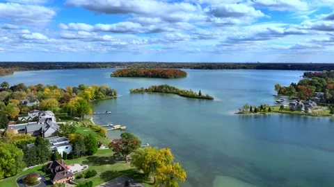 Aerial drone captures stunning fall colors at Orchard and Cass Lakes in Michigan Stock Footage 220035267